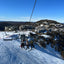 three snowboarders taking part in a Skin Ski and Surf Snow Trip on a chairlift at mount hotham